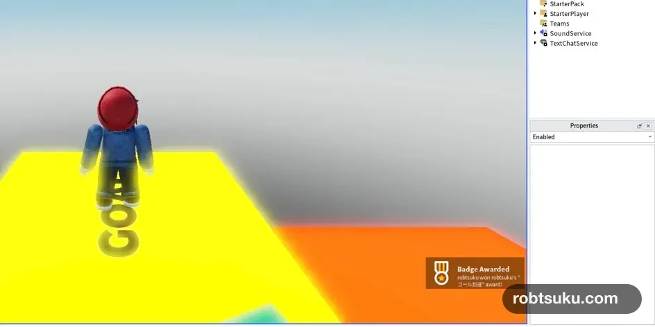 A player standing on the yellow goal after earning a Roblox badge
